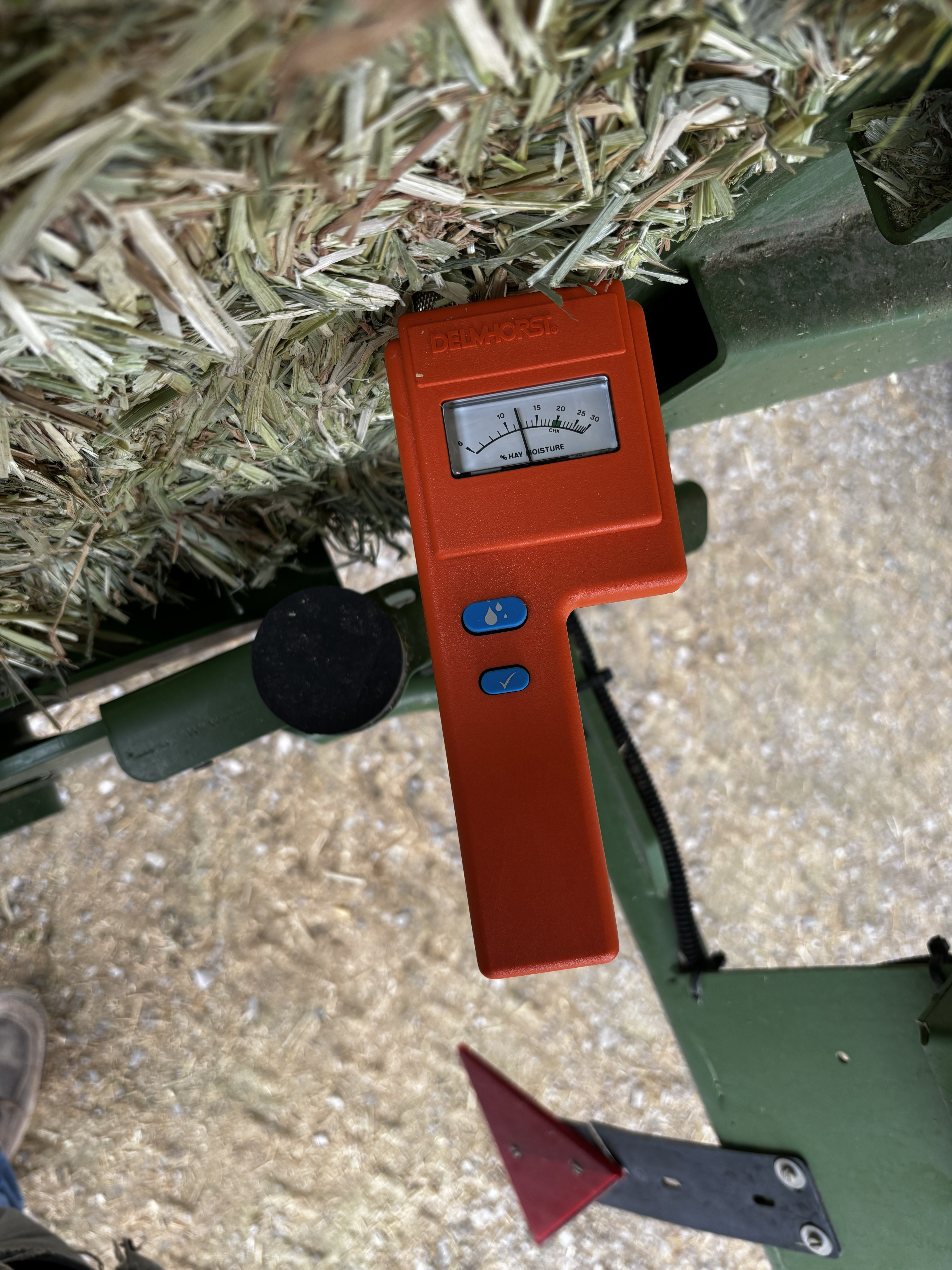A hay moisture meter checking moisture before baling.